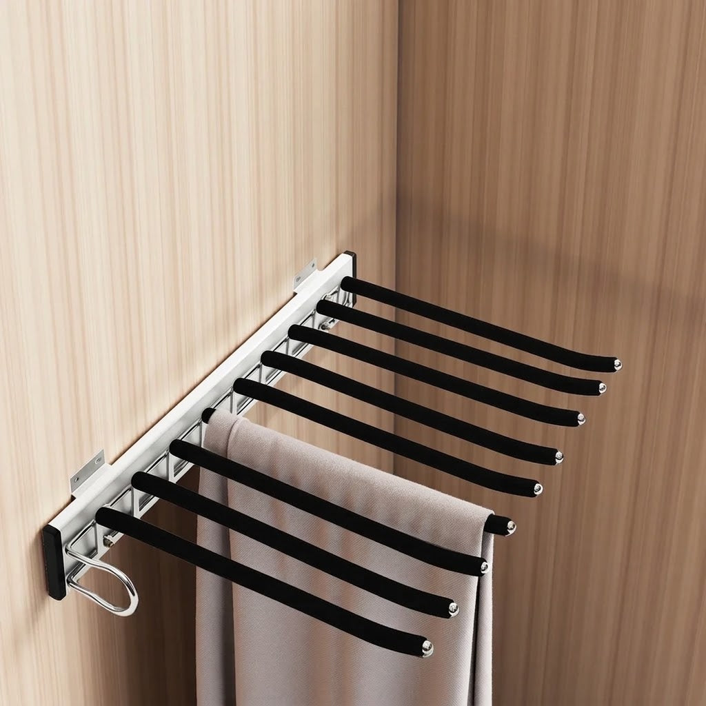 Porte-pantalons coulissant fixé dans une armoire, un pantalon posé sur une tige et les autres libres